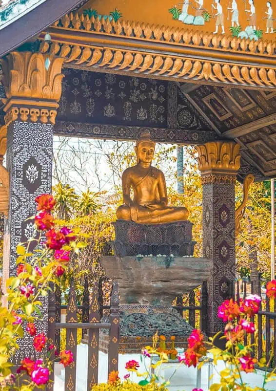 3 Days In Luang Prabang Itinerary: ULTIMATE Guide 7 buddha underneath a pavilion at one of the incredible temples worth visiting on your luang prabang itinerary