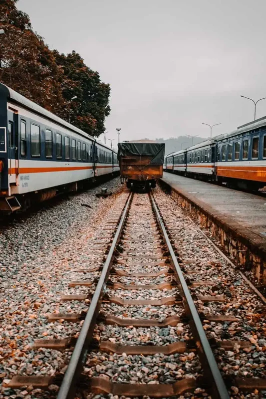 Railway tracks paving the way to a stationary Vietnam sleeper train awaiting departure