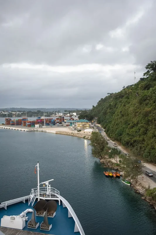 the bows of the cruise ship starting to pull away from the port in port vila vanuatu
