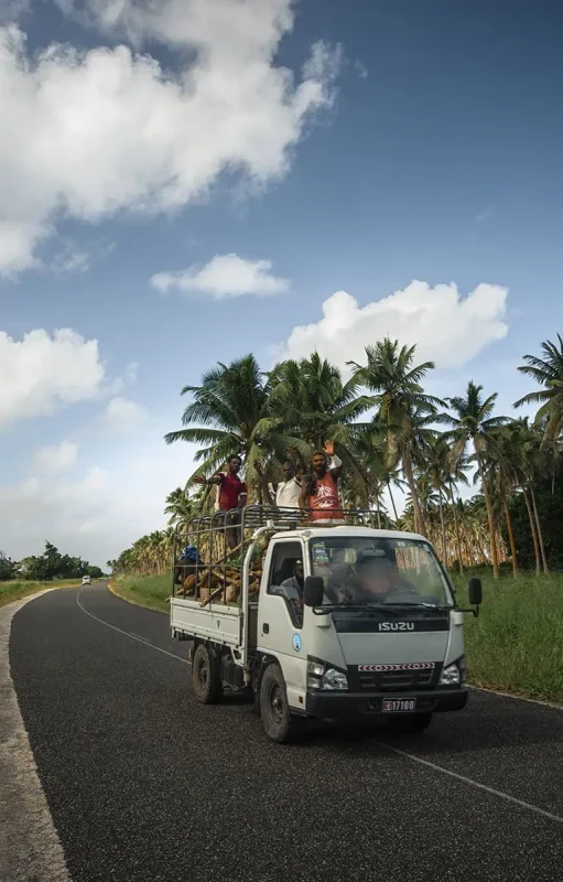 locals waving while passing us on the road in a white truck in port vila vanuatu