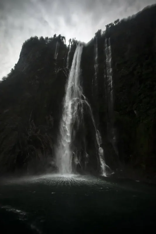 Close view of a roaring stirling falls in Milford Sound as it crashes into the water below.