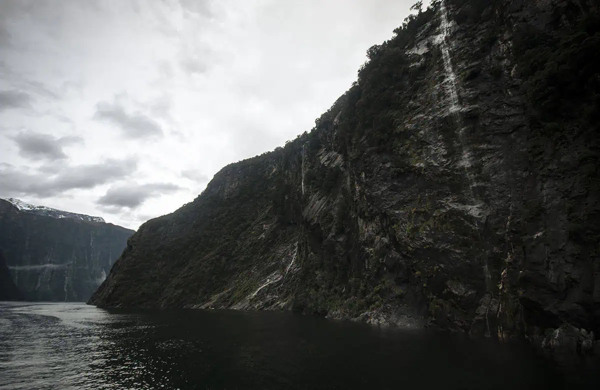 Best Waterfalls In Milford Sound Worth Checking Out 12 A part of the four sisters waterfall cascades down a steep cliffside into the still water, one of the best waterfalls in milford sound
