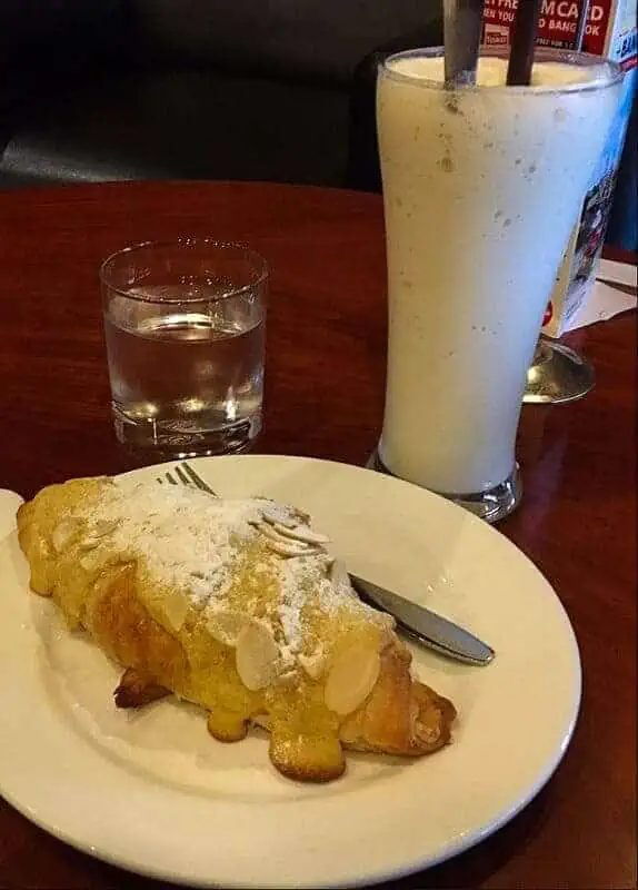 almond croissant and smoothie from joma cafe, one of the best bakeries in luang prabang