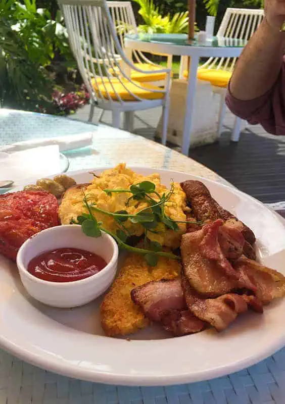 Where To Eat In Rarotonga: BEST Restaurants & Cafes 2025 15 Hearty breakfast plate with scrambled eggs and bacon, served at the lazy trout, perfect for starting a day of island exploration.