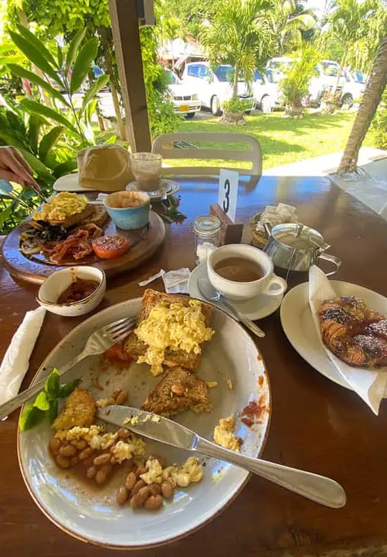Where To Eat In Rarotonga: BEST Restaurants & Cafes 2025 5 A hearty breakfast spread with various dishes on a table at LBV cafe.