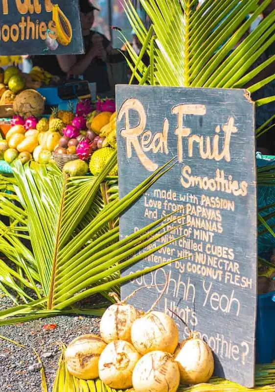 Where To Eat In Rarotonga: BEST Restaurants & Cafes 2025 9 A vibrant street food stall offering 'Real Fruit Smoothies' with fresh coconuts, a testament to the unique flavors available at Rarotonga