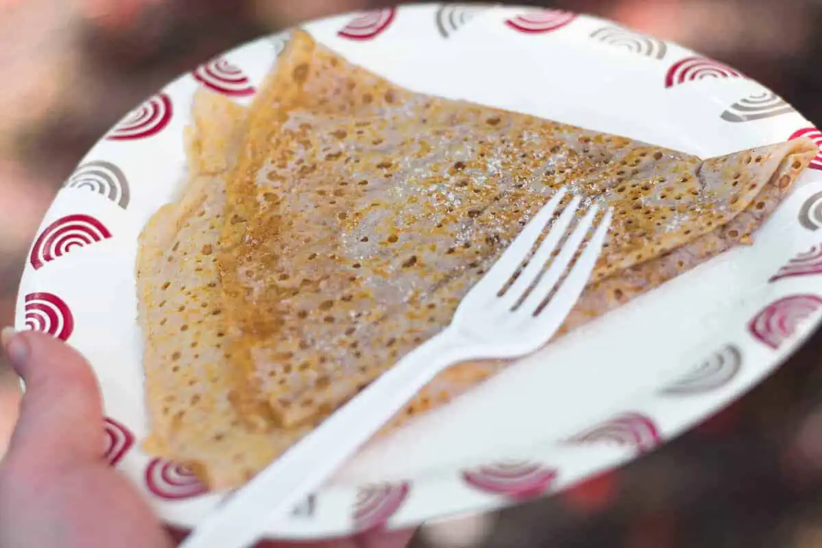 Where To Eat In Rarotonga: BEST Restaurants & Cafes 2025 10 A golden brown crepe sprinkled with sugar, a simple yet delightful dessert found at the Punanga Nui Market, a popular breakfast spot in Rarotonga