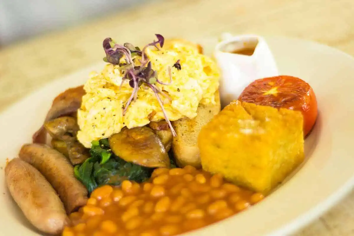 Where To Eat In Rarotonga: BEST Restaurants & Cafes 2025 7 Scrumptious full English breakfast plate, a perfect morning start at LBV, a recommended place to eat in Rarotonga, featuring sausages, eggs, and beans.